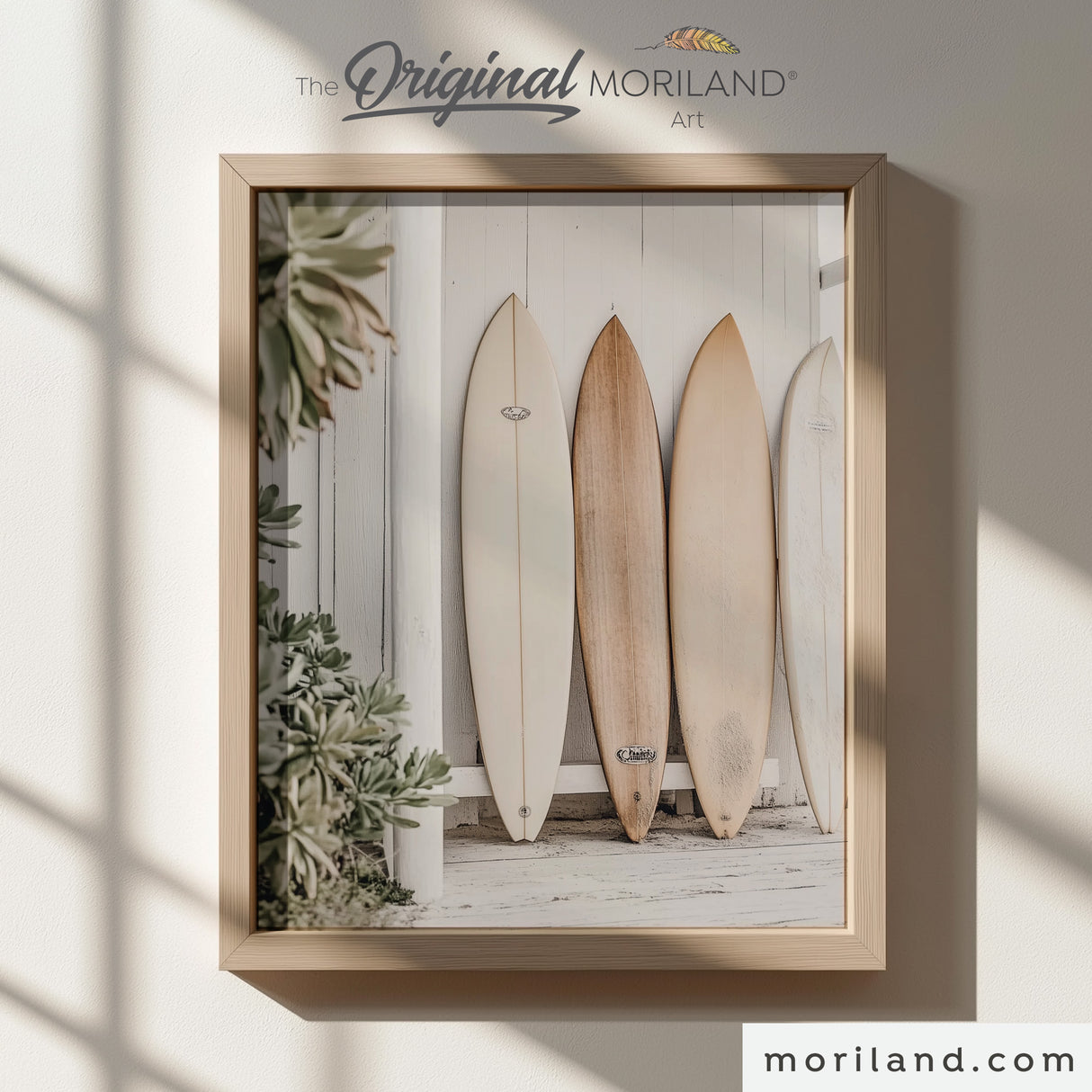 Modern heritage coastal style photographic print of neutral wood and white surfboards leaning against a white wooden beach shack wall, displayed in a light wood frame for a beach nursery or coastal playroom by MORILAND.