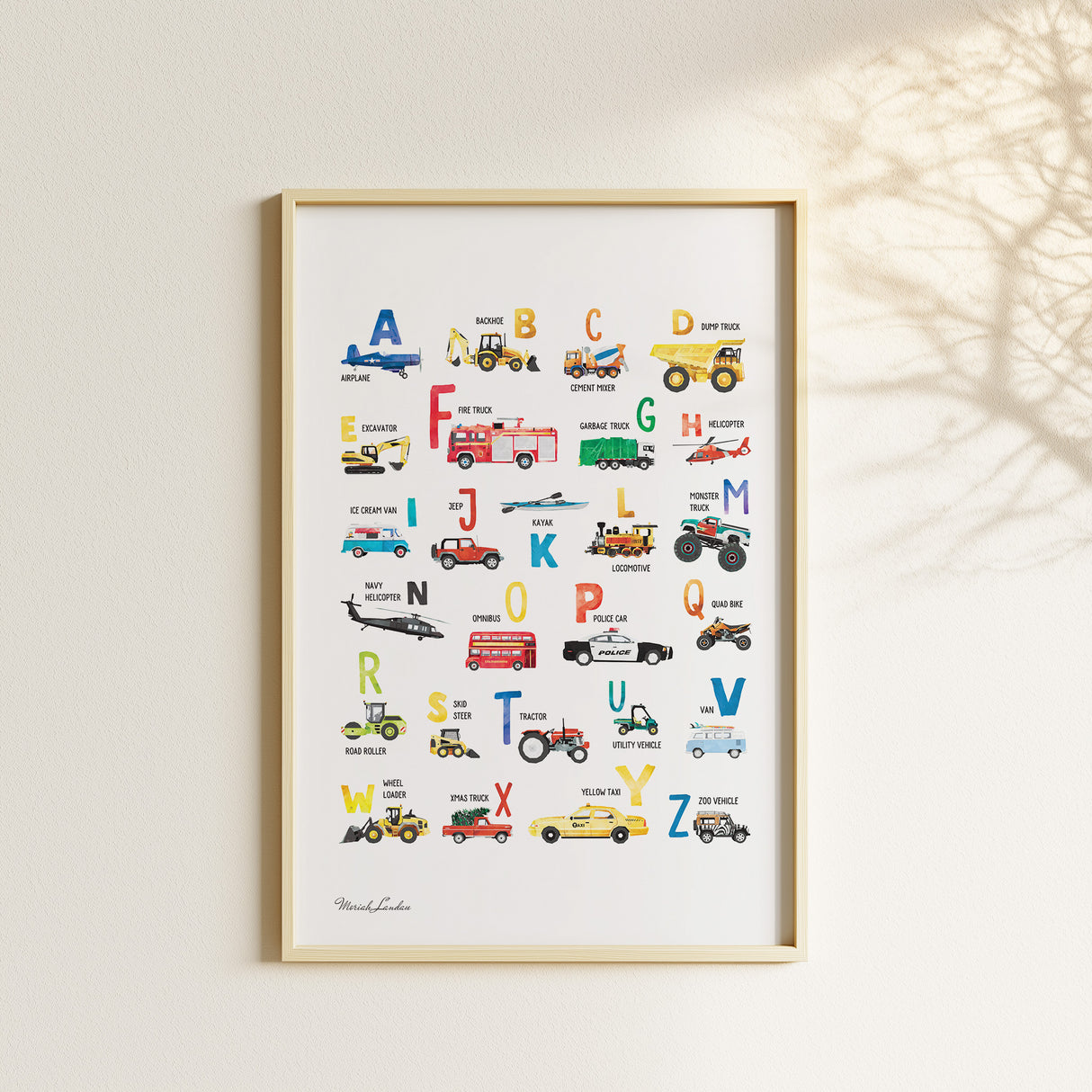 Watercolor vehicle alphabet poster displayed with matching transportation prints in a neutral children’s bedroom.