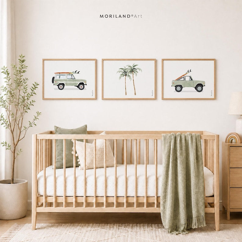Sage green surf car and palm tree wall art set in natural wood frames above a crib in a neutral nursery