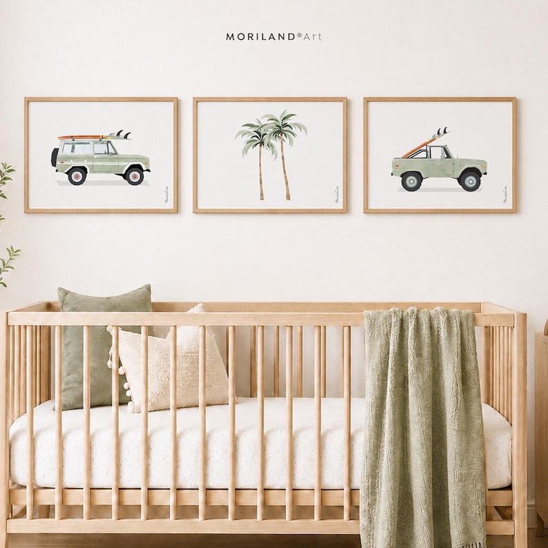 Set of three sage green surf car and palm tree nursery prints above a wooden crib in a neutral coastal nursery
