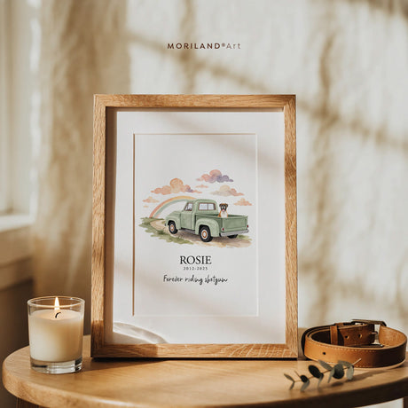 Custom dog portrait memorial print of a boxer riding in a sage green 50s pickup under a rainbow, with the name Rosie and “Best co-pilot ever,” framed in oak beside a candle and leather leash