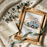 Pet remembrance gift: framed watercolor print of a German shepherd in a vintage open-top 4x4 with the name Bear, wrapped in kraft paper with a green ribbon, eucalyptus and a sympathy card