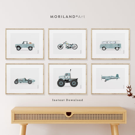 Set of 6 vintage-style transportation art prints for a boys' nursery, featuring a pale blue watercolor truck with Goldendoodle puppies, a classic airplane, a tractor, and a motorcycle. Shown in a realistic American-style bedroom with a brown leather chair and a navy blue bunk bed.