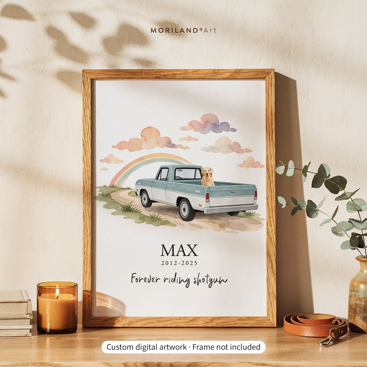 Personalized dog memorial print of a golden retriever riding in a vintage pale blue pickup toward a rainbow, with the name Max, years and “Forever riding shotgun,” in an oak frame on a wooden table