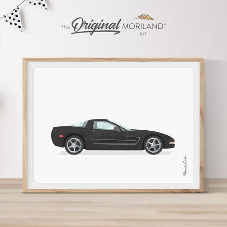 Modern heritage watercolor style illustration of a black C5 Corvette classic sports car side profile, displayed in a light wood frame for a car themed nursery or boy's room wall decor by MORILAND.