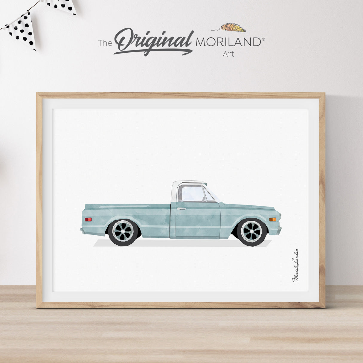 Modern heritage style watercolor illustration of a pale blue 1969 Chevy C10 pickup truck inside a light wood frame, perfect for a classic Chevrolet vehicle nursery or boy's room wall decor by MORILAND.
