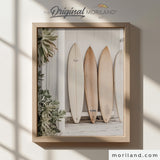Modern heritage coastal style photographic print of neutral wood and white surfboards leaning against a white wooden beach shack wall, displayed in a light wood frame for a beach nursery or coastal playroom by MORILAND.