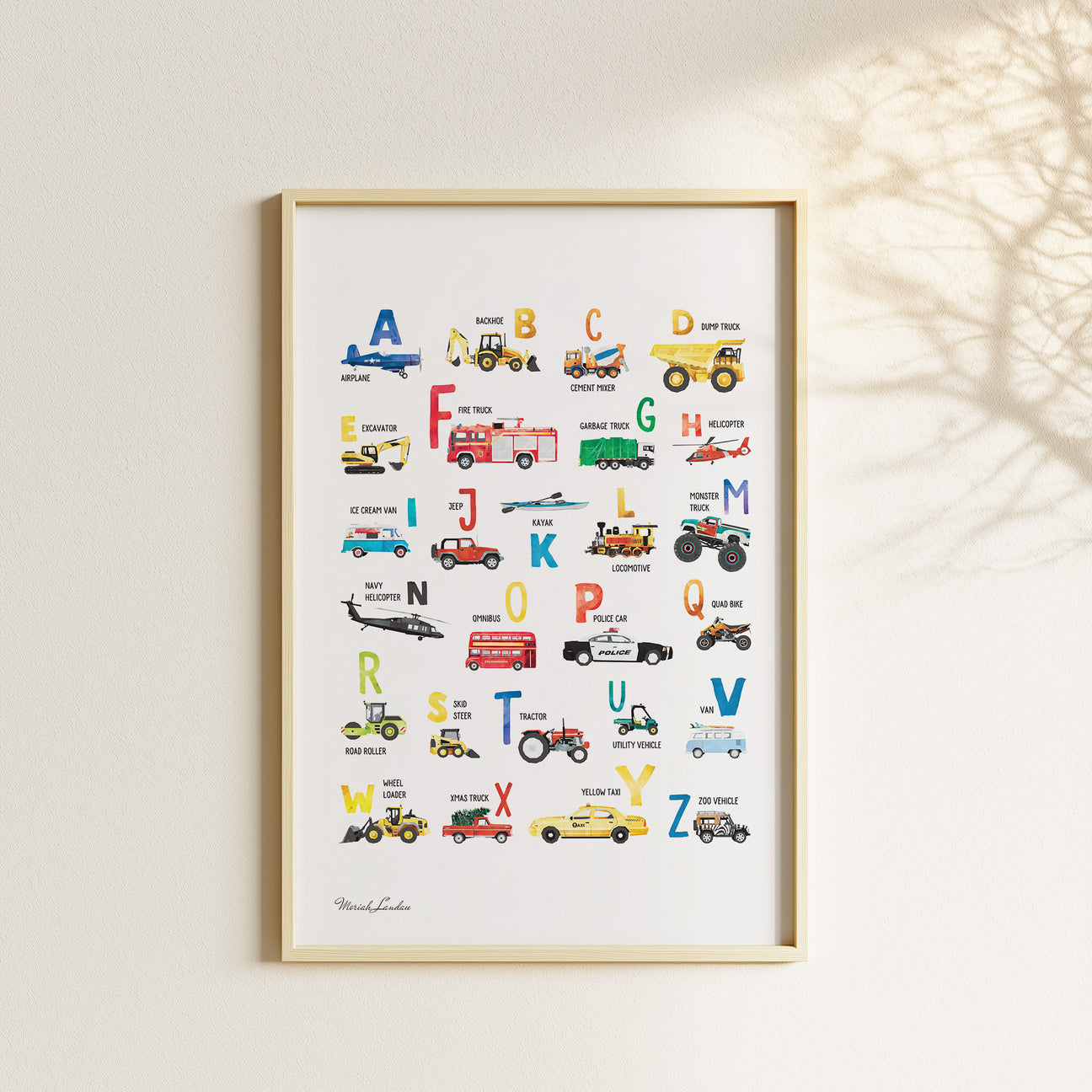 Watercolor vehicle alphabet poster displayed with matching transportation prints in a neutral children’s bedroom.
