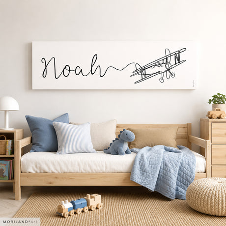 Personalized Noah one-line airplane canvas wall art displayed in a modern blue and neutral children's bedroom