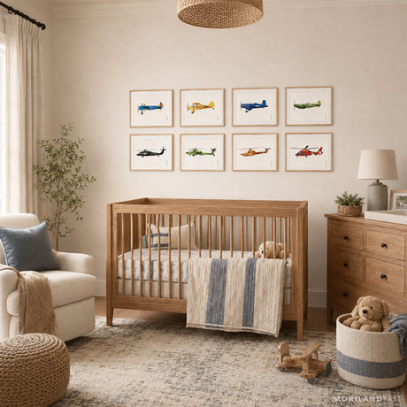 Eight watercolor airplane and helicopter prints in light wood frames above a crib in a warm neutral boys nursery.