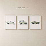 Three wrapped canvases featuring vintage sage green pickup truck, SUV, and sports car artwork arranged as a set on a neutral wall.