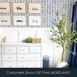 MORILAND customer room with framed vintage car wall art above a dresser