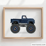Navy blue vintage monster truck printable wall art in a light wood frame by MORILAND