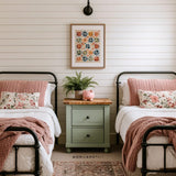 Vintage patchwork star wall art above twin beds with pink bedding and farmhouse decor