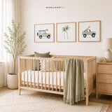Coastal nursery with three sage green surf vehicle and palm tree printable wall art designs above a wood crib