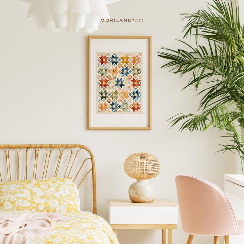 Vintage quilt inspired watercolor wall art framed above a cozy bed and desk in a bright cottage style room