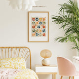 Vintage quilt inspired watercolor wall art framed above a cozy bed and desk in a bright cottage style room