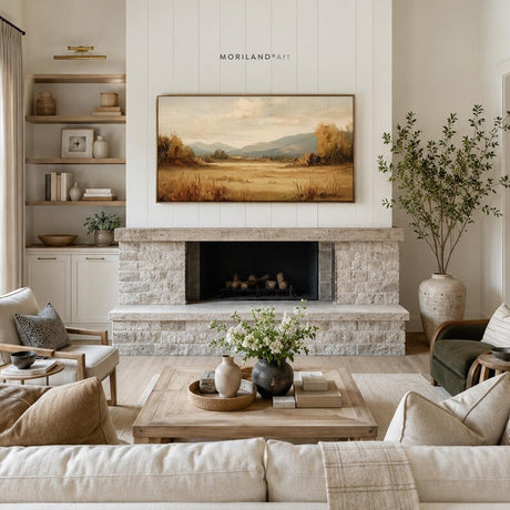Fall landscape Frame TV art displayed above fireplace in neutral living room