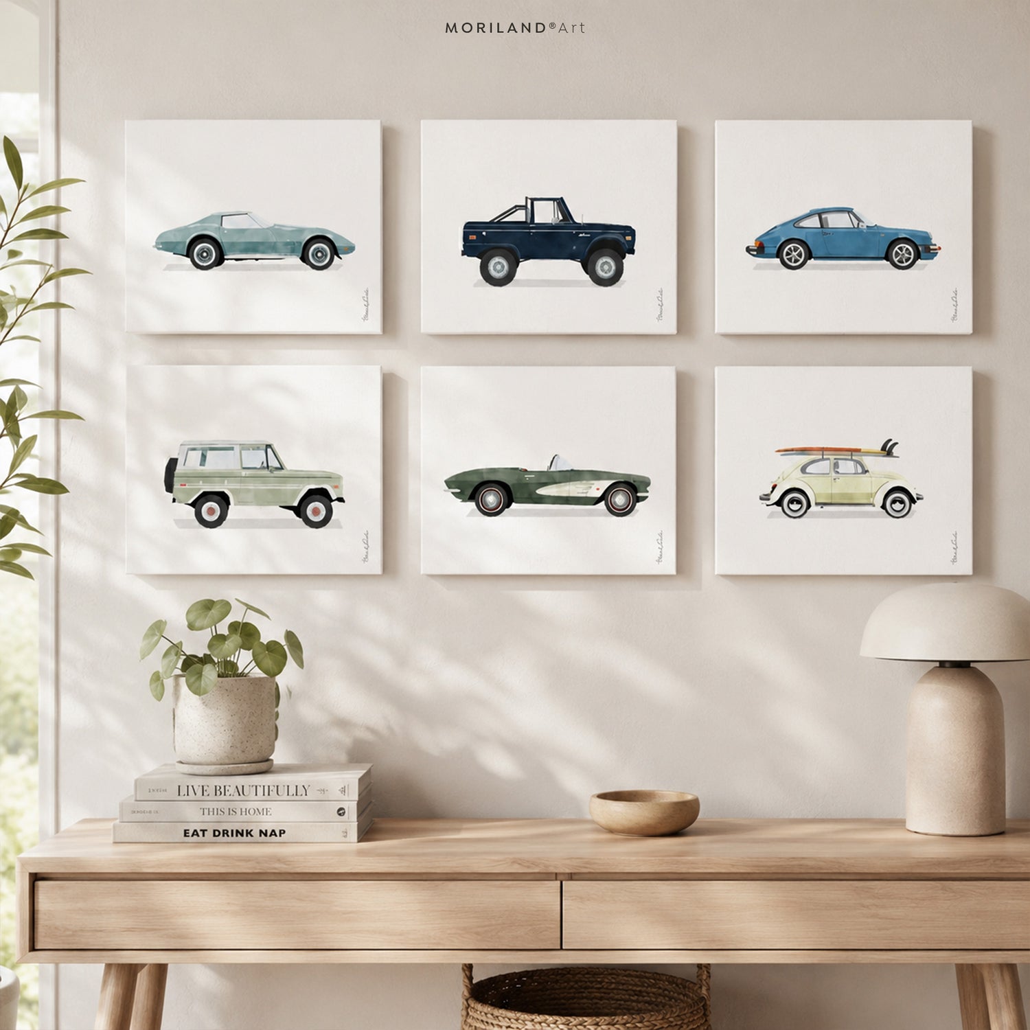 Set of six vintage watercolor car prints displayed in a modern Scandinavian-style room above a light wood console table.
